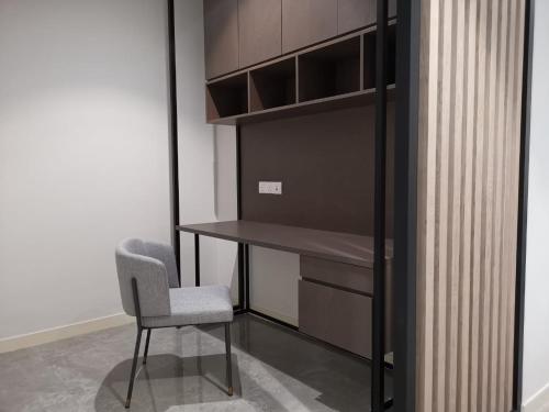 a desk and a chair in a room at The Ooak Suites and Residence@ Kiara 163 in Kuala Lumpur