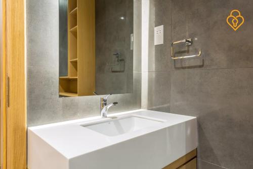 La salle de bains est pourvue d'un lavabo blanc et d'un miroir. dans l'établissement Keysplease Modern 1 BR Beach Apt 07A Murjan 1, JBR, à Dubaï