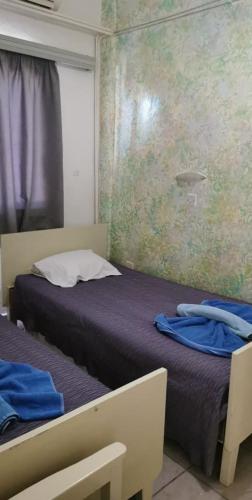Postel nebo postele na pokoji v ubytování Simos Magic Hotel Apts