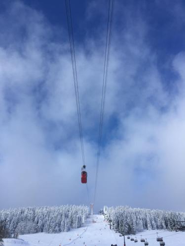 a ski lift in the air in the snow at Chalet & Apart Fichtelberger Blick in Kurort Oberwiesenthal