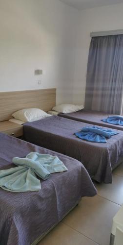 Postel nebo postele na pokoji v ubytování Simos Magic Hotel Apts