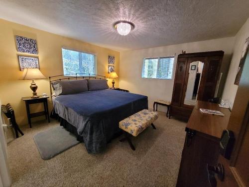 a bedroom with a bed with a blue comforter at Misty Valley Inn in Forks
