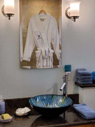 a bathroom with a sink with a white robe on a mirror at Misty Valley Inn in Forks