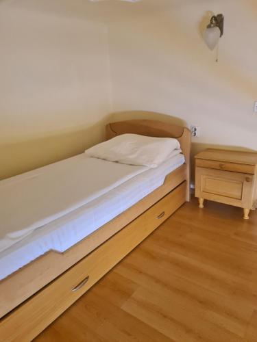 a bedroom with a bed and a night stand at Siesta in Kikinda