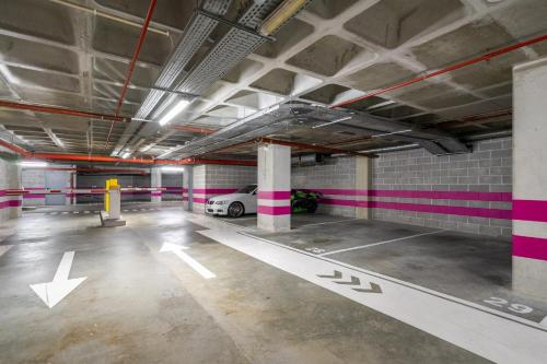 an empty parking garage with a car parked in it at WHome Panoramic View with Elevator, AC, Garage perfect for Families & Business Travellers in Lisbon