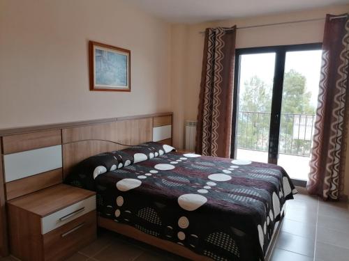 a bedroom with a bed and a large window at Cumbre Las Jarras in Polop