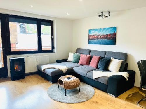 a living room with a couch and a fire place at Modernes Apartment Seefeld and Chill RELAX im Zentrum mit Netflix for free in Seefeld in Tirol