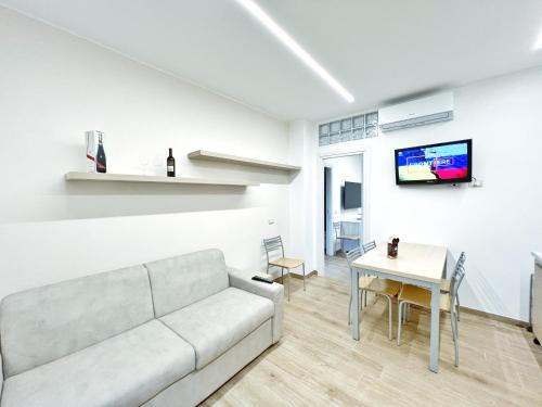 a living room with a couch and a table at Luxury Tugurio in Arma di Taggia