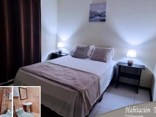 a bedroom with a bed and two lamps on tables at Casa Colima in Isla de Tibás