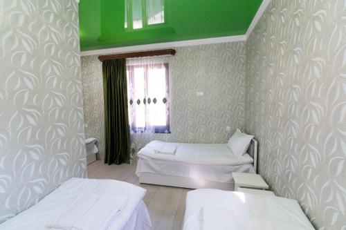 a room with two beds and a window at Rafting House in Odzun