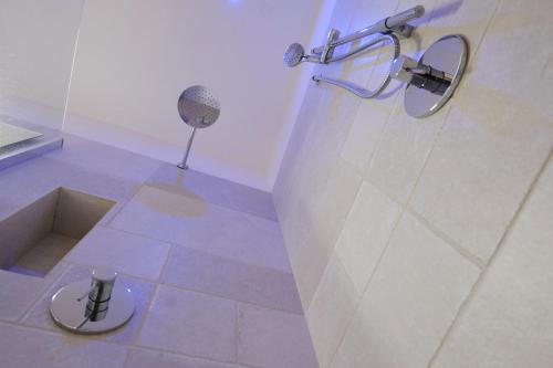a bathroom with a shower with a microphone on the floor at Missipezza Residence a Frassanito in Alimini