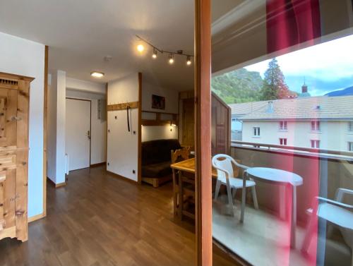 a room with a window and a table and a bedroom at Studio Brides les Bains Savoie in Brides-les-Bains