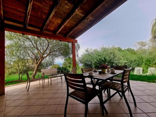 a patio with a table and chairs on a patio at L'oasi nello Zingaro in Scopello
