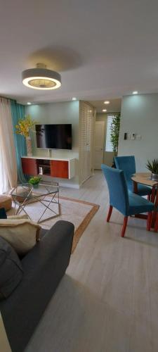 a living room with a couch and chairs and a table at Almond Grove at Sand Castle in Ocho Rios