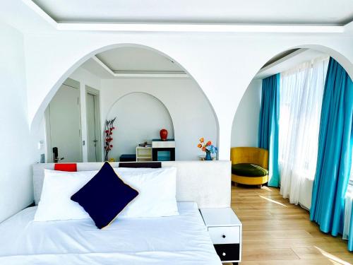 a bedroom with a white bed and blue curtains at Apex Hotel in Istanbul