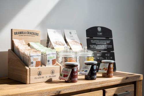 a table with jars of food and other products on it at L'ARTiste in Lessines