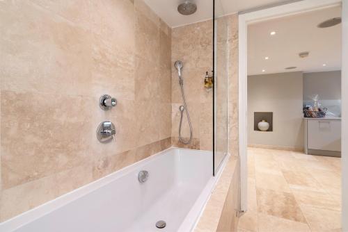 a bathroom with a shower and a tub at Bath Circle Camden Lodge House in Bath