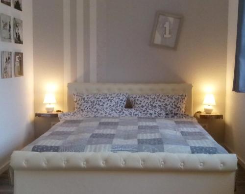 a bedroom with a large bed with a blue and white bedspread at Villa Regina in Möhnesee