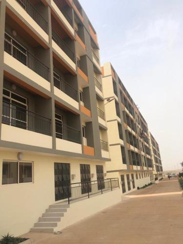 a large apartment building with stairs in front of it at Mo Residence SD City in Dakar