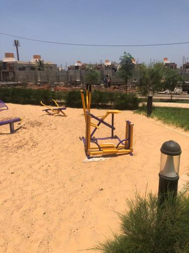 a couple of chairs sitting on a sandy beach at Mo Residence SD City in Dakar