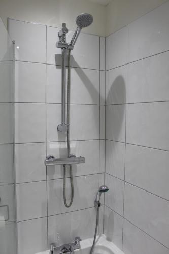 a shower with a shower head and a sink at Luxury Serviced Apartments in Bradford