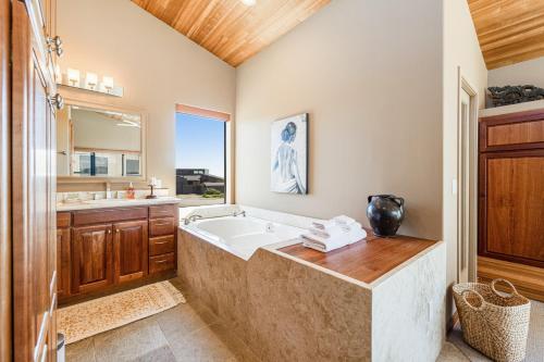 a bathroom with a tub and a sink at Da Yaya House in Sea Ranch