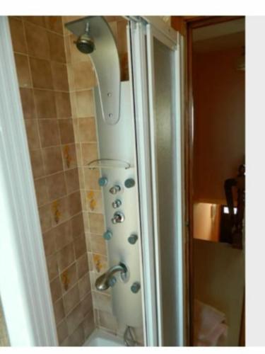 a shower in a bathroom with a shower head at Apartamento Puerto Finisterre in Fisterra