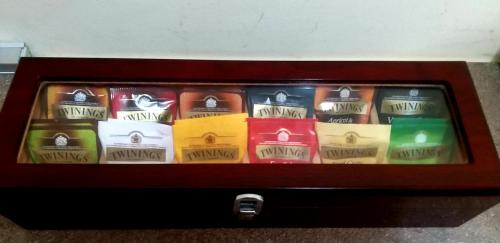 a wooden box filled with different colored packets at Smiths & Herreros in Genova