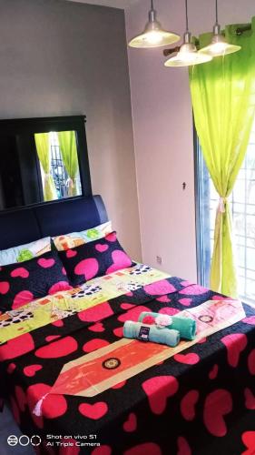 a bedroom with a bed with hearts on it at Bdr Bukit Tinggi Klang Tropicana Garden Homestay in Klang