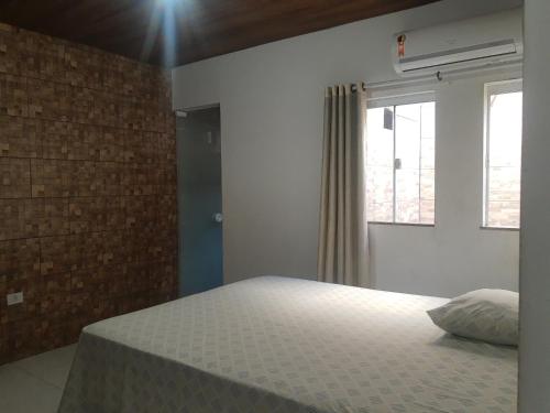 una camera con letto e finestra di Apartamento com suíte, localizado na Avenida Silvio Silva, n 33, bairro Hernani Sa, Ilhéus - Ba, sem garagem a Ilhéus