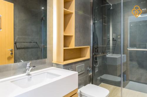 a bathroom with a sink and a shower and a toilet at Modern Beach Studio Murjan 5, 22B in Dubai
