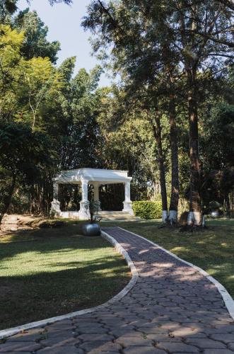 a walkway in a park with a gazebo at Rancho Macloy Hotel Spa & Social Events in Yautepec