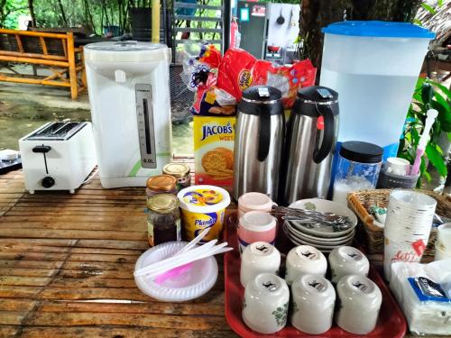 a table with some food and drinks on it at Betik Garden Home in Machang