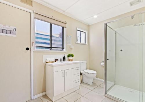 a bathroom with a shower and a sink and a toilet at Metung Akora 2Bdrm Apartment 1 - Pets & Boats welcome! Close to Town, Free Wifi & Netflix in Metung