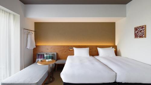 Un ou plusieurs lits dans un hébergement de l'établissement HOTEL STRATA NAHA