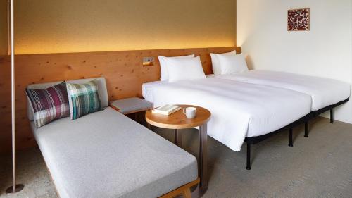Un ou plusieurs lits dans un hébergement de l'établissement HOTEL STRATA NAHA