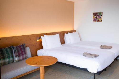 Un ou plusieurs lits dans un hébergement de l'établissement HOTEL STRATA NAHA