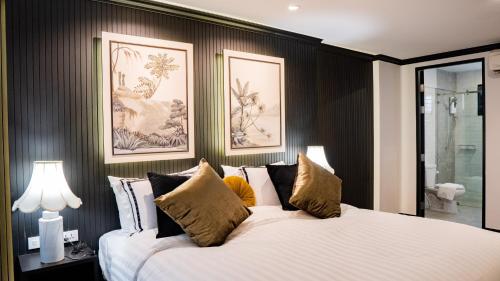 a bedroom with two beds and two lamps at BAAN 125 STAY Phuket in Phuket Town