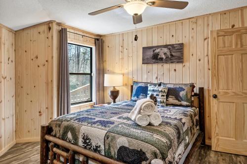 a bedroom with a bed and a ceiling fan at Gnoming Around in Gatlinburg