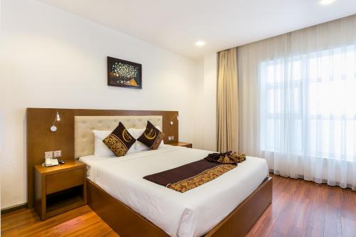 Ένα ή περισσότερα κρεβάτια σε δωμάτιο στο Centre Hotel