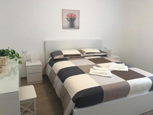 a bedroom with a large bed with two towels on it at Chioggia House di Marco in Chioggia