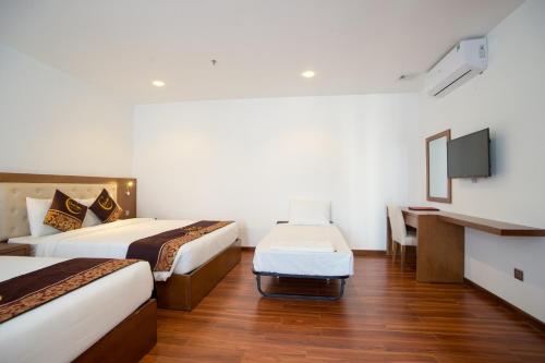 Ένα ή περισσότερα κρεβάτια σε δωμάτιο στο Centre Hotel