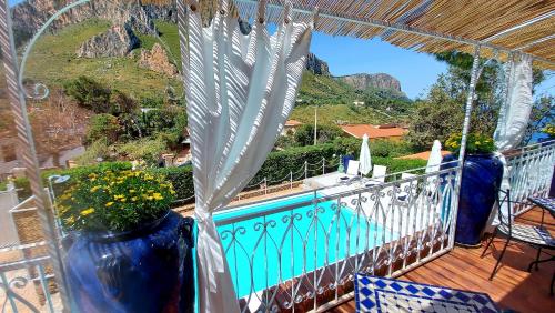 a balcony with a view of a pool and mountains at VFH Villa Flavia Eco B&B - 50 metri dal mare in Santa Flavia