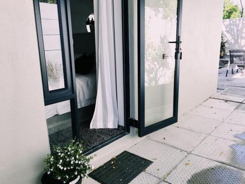 a room with a door with a mirror and a plant at 9 Windsor House in Tokai