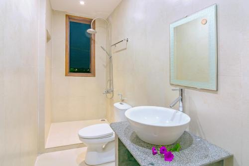 a bathroom with a sink and a toilet and a mirror at hoi an center town in Hoi An