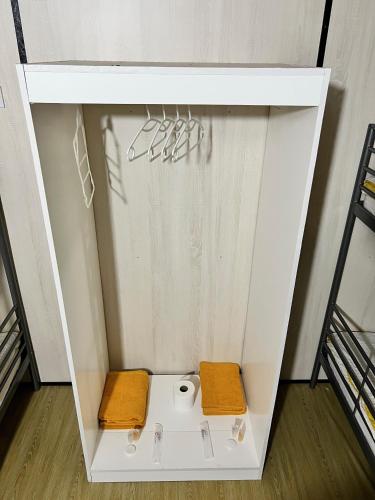 a white cabinet with a toilet in a room at Bertam Cottage Penang in Kepala Batas