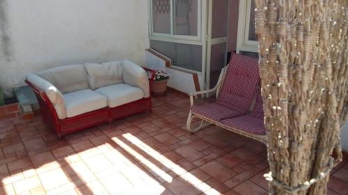 a living room with a couch and two chairs at Alla Busiata in Trapani