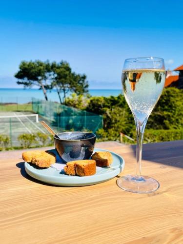 une assiette de nourriture et un verre de vin sur une table dans l'établissement Hôtel De La Terrasse, à Varengeville-sur-Mer