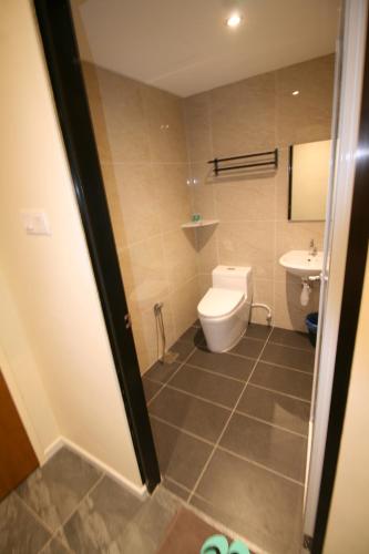 a bathroom with a toilet and a sink at Pangkor Pop Ash Hotel in Pangkor