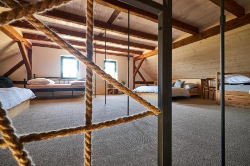 a room with two beds and a rope bridge at Statek 85 in Mařenice
